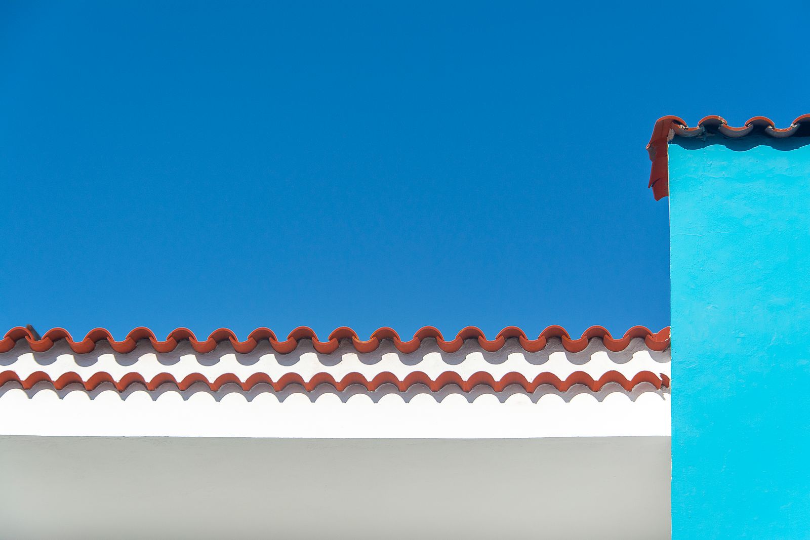 The Solace Sands spa house, a low stucco building beneath red rock